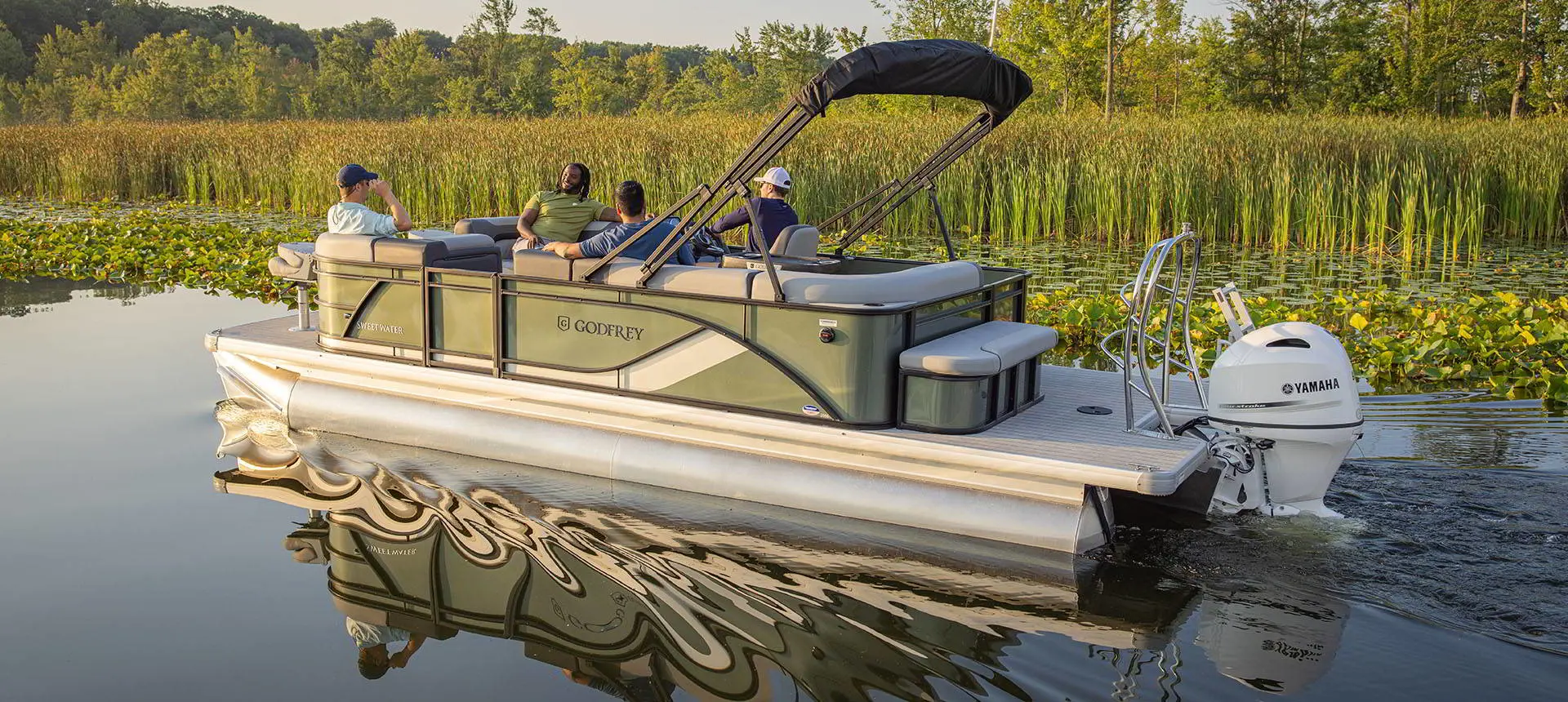 4 guys cruising on a Godfrey AquaPatio pontoon boat and finding a spot to fish.