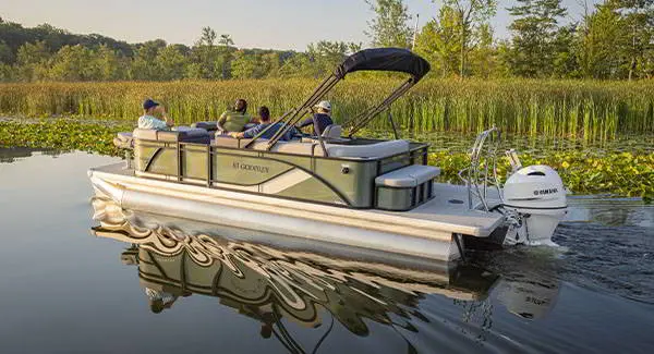 4 guys cruising on a Godfrey AquaPatio pontoon boat and finding a spot to fish.