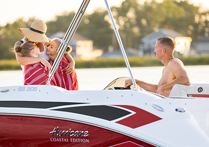 A family enjoying a loving moment on their Hurricane boat.