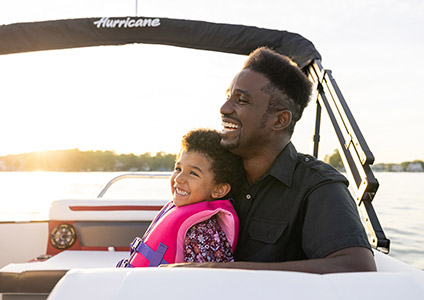 A father and his daughter having a good time on their boat.