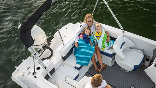 family enjoying the lake on a hurricane sundeck sport ob deck boat