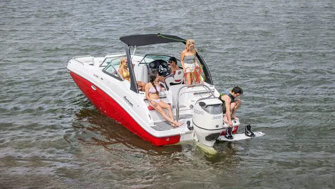 family floating and preparing to wake board with their hurricane sundeck OB deck boat