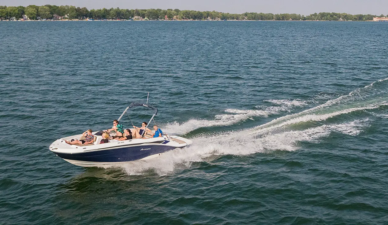 hurricane sundeck sport i/o deck boat speeding across a lake