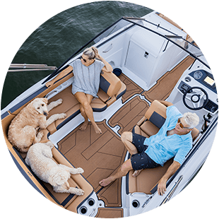 family and their dogs relaxing on a hurricane deck boat