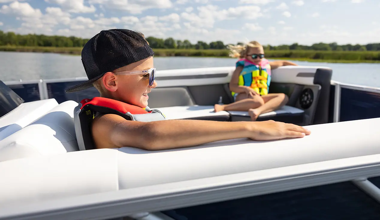 boy smiling on a hurricane fundeck boat