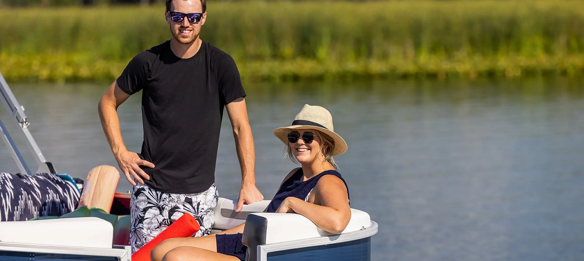 husband and wife on the bow of a hurricane fundeck boat