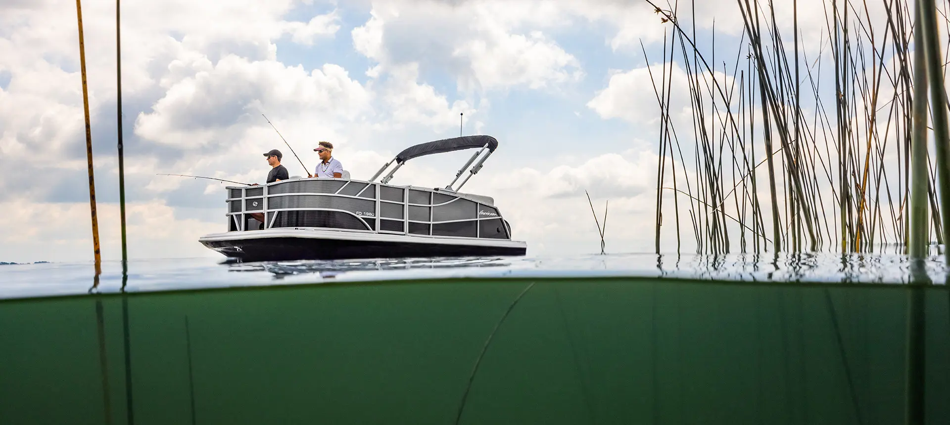 2 men fishing off the bow of a hurricane fundeck boat