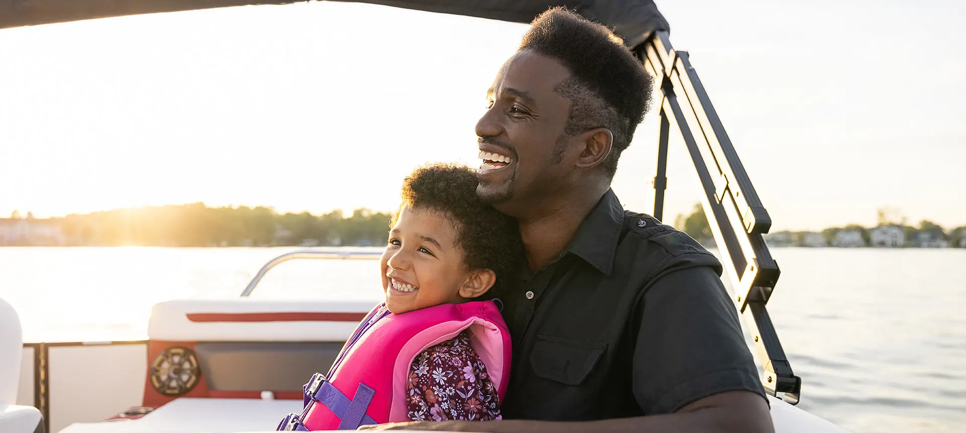 father and child smiling on a hurricane fundeck boat