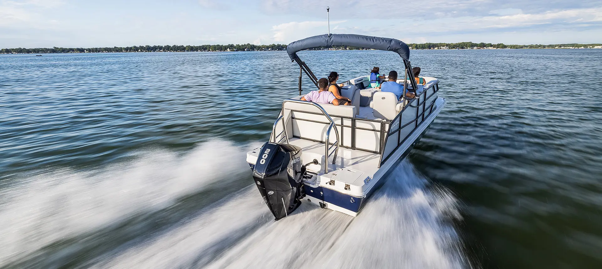 stern view of a hurricane fundeck boat speeding across a lake