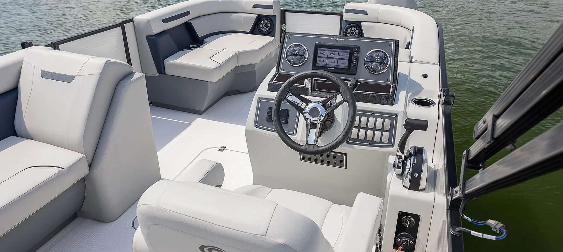 steering wheel and switches at the helm of a hurricane fundeck boat