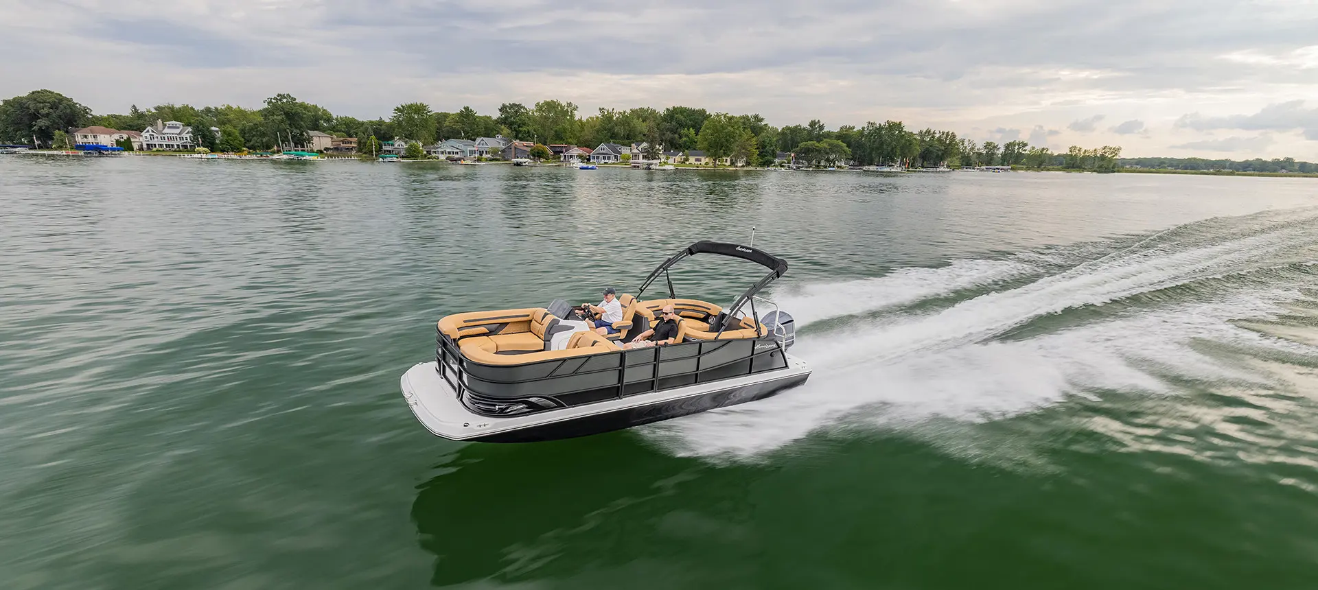 hurricane fundeck boat cruising across a lake
