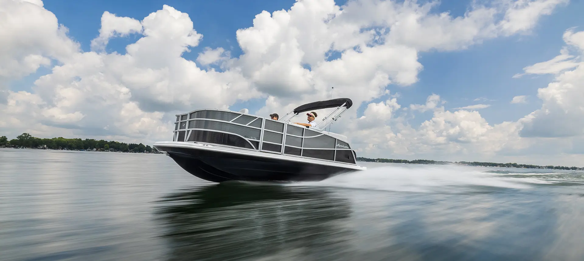 Side view of a Hurricane Fundeck 1960 REF OB speeding on the lake.