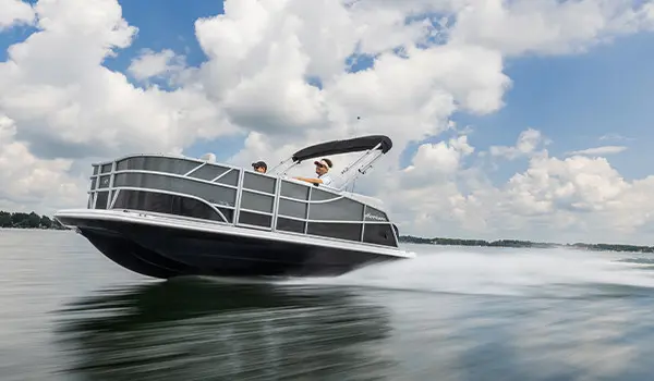 Side view of a Hurricane Fundeck 1960 REF OB speeding on the lake.