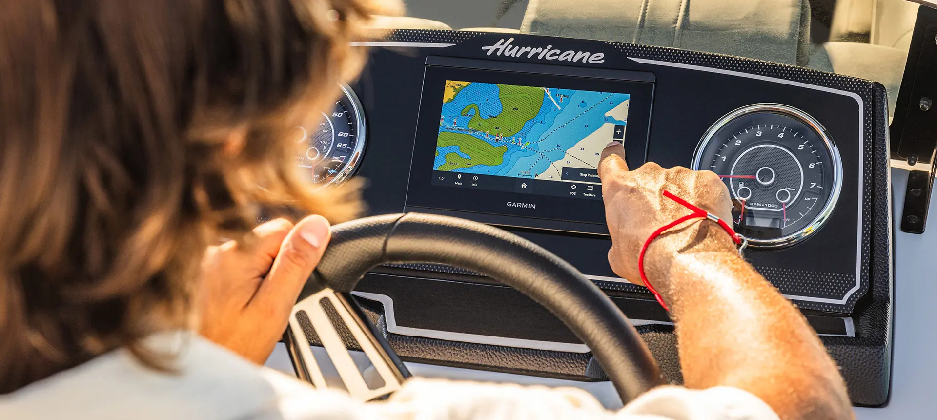 man points at console dash on hurricane fundeck 2360 sfl ob