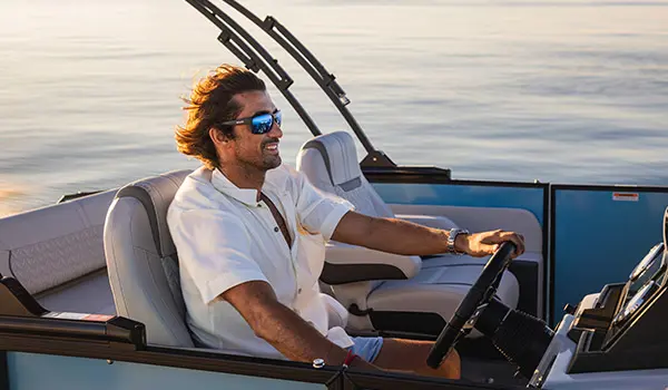 captain behind wheel of hurricane fundeck 2360 sfl ob