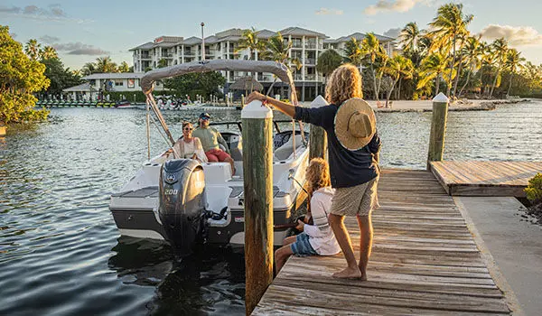 woman on dock standing next to hurricane sundeck 217 ob