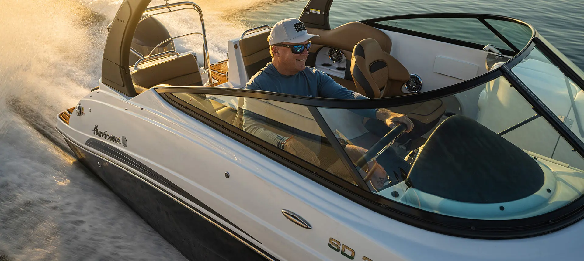 Man speeding across water on a Hurricane SunDeck 2486 OB.