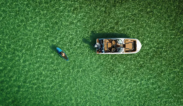 Overhead view of a Hurricane SunDeck 2486 OB and paddleboard.