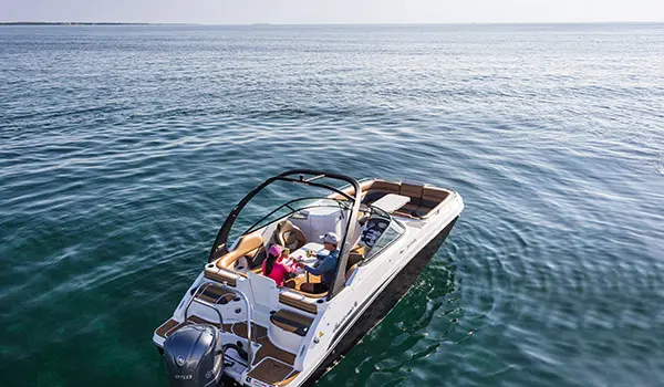 Overhead view of a couple relaxing at table seating on a Hurricane SunDeck 2486 OB.