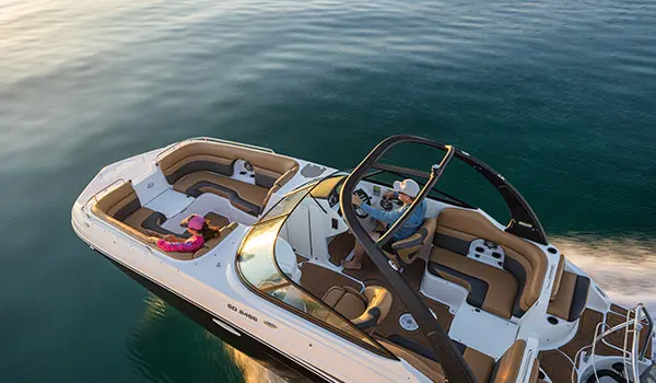 Overhead view of a couple cruising across lake on a Hurricane SunDeck 2486 OB.