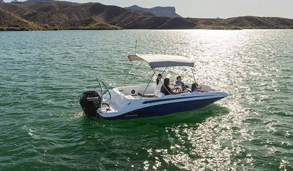 Aerial view of a Hurricane SunDeck Sport 185 OB deck boat floating on a lake.