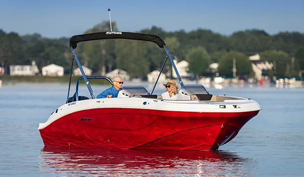 Bow focused view of a couple floating the lake on their Hurricane SunDeck Sport 2050 OB deck boat.