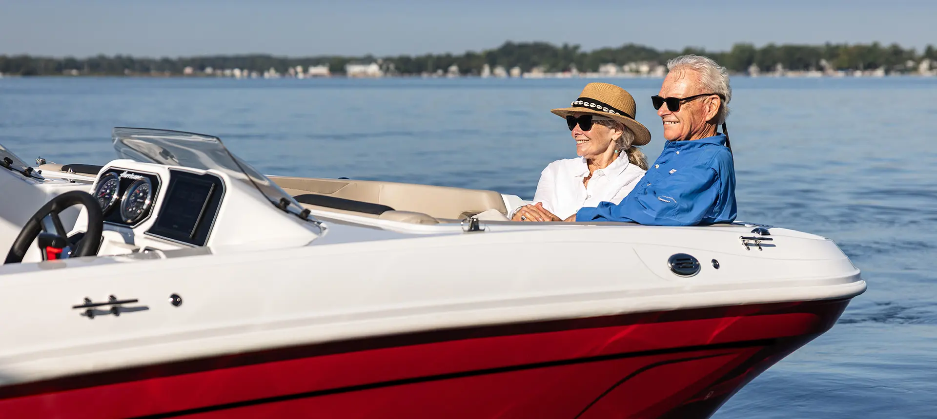 Couple relaxing on the bow seating on a Hurricane SunDeck Sport 2050 OB deck boat.