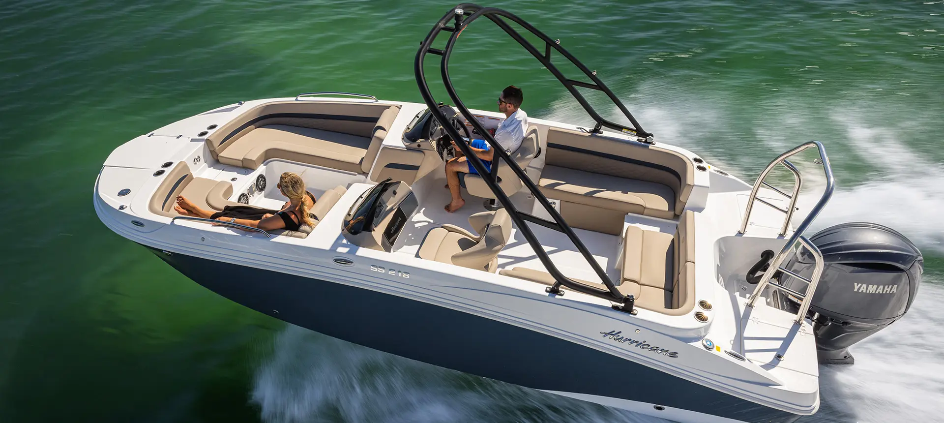 Aerial view of a Hurricane SunDeck Sport 218 OB deck boat on the ocean.