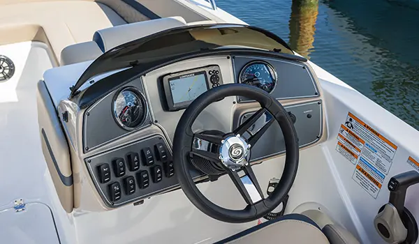 Helm and steering wheel on a Hurricane SunDeck Sport 218 OB deck boat.