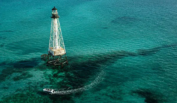 Aerial view of a Hurricane SunDeck Sport 218 OB deck boat on the ocean.