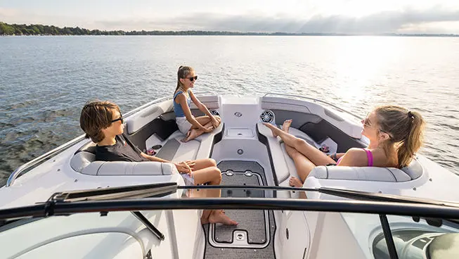 kids sitting on the bow seating on a hurricane sundeck ob boat