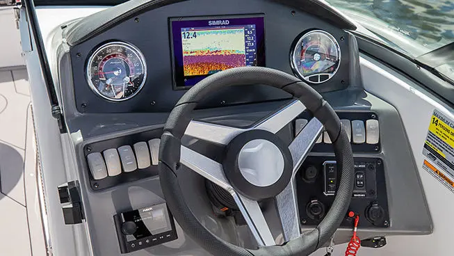 steering wheel and gauges on a the helm of a hurricane sundeck ob boat