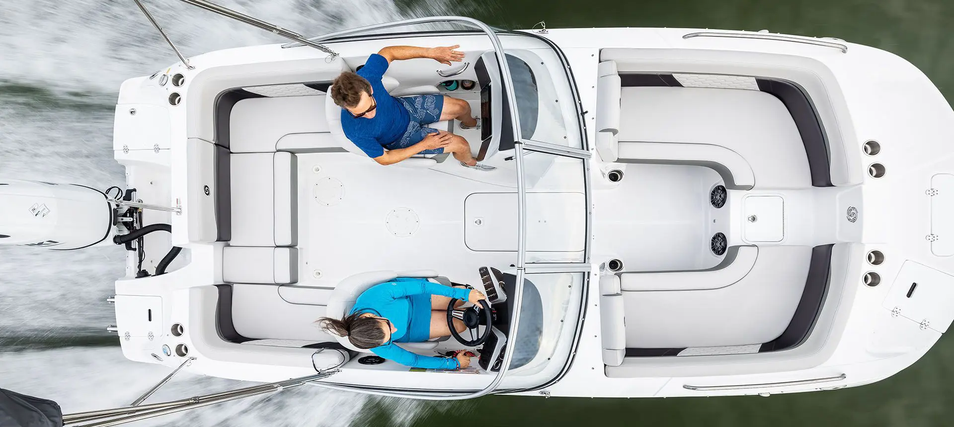 aerial view of a couple in the co-captain's chairs on a hurricane sundeck ob boat