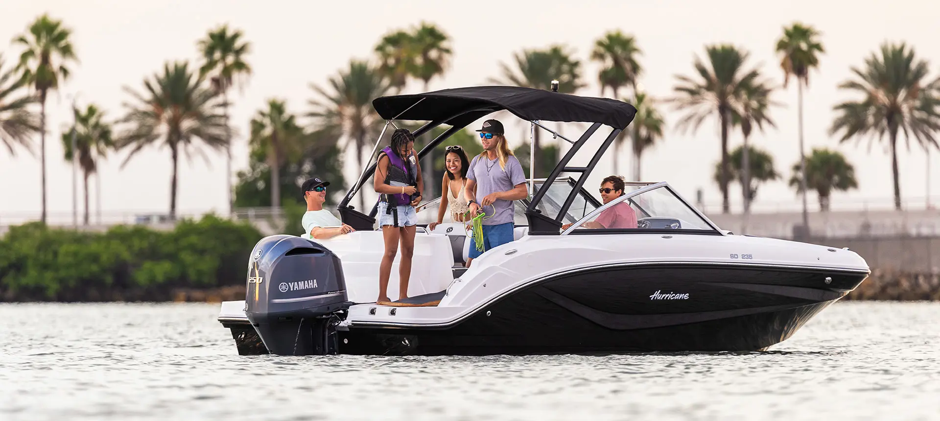 family prepares rope for watersports on hurricane sundeck 235 ob