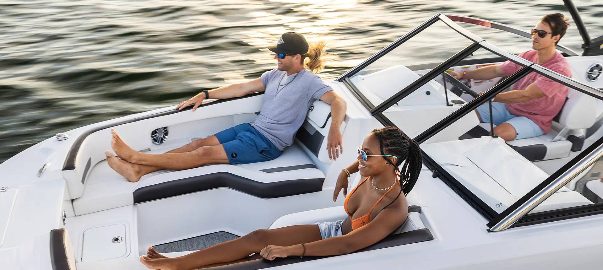 male and female lounge on front of cruising hurricane sundeck 235 ob