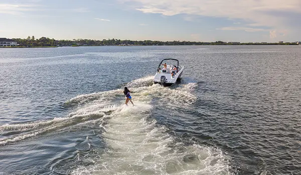 wake boarder gets towed behind a hurricane sundeck 235 ob
