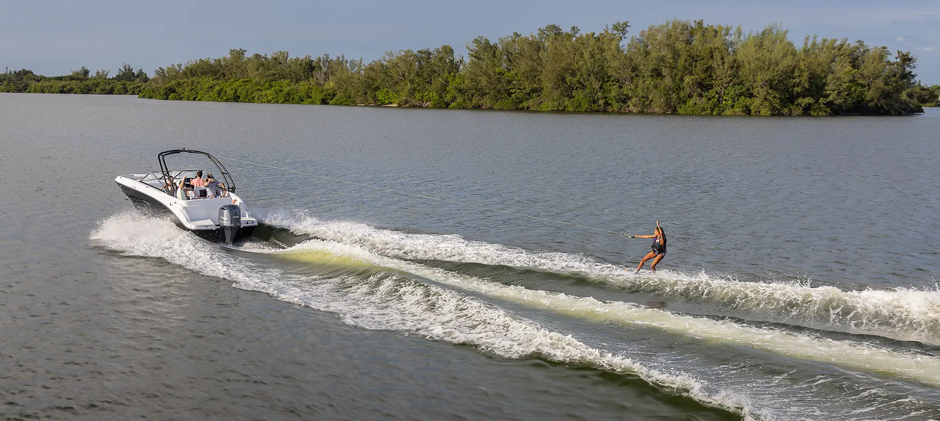 side view of wakeboard being towed behind a hurricane sundeck 235 ob
