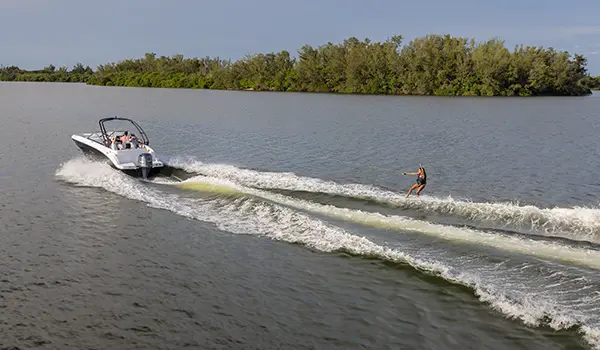 side view of wakeboard being towed behind a hurricane sundeck 235 ob