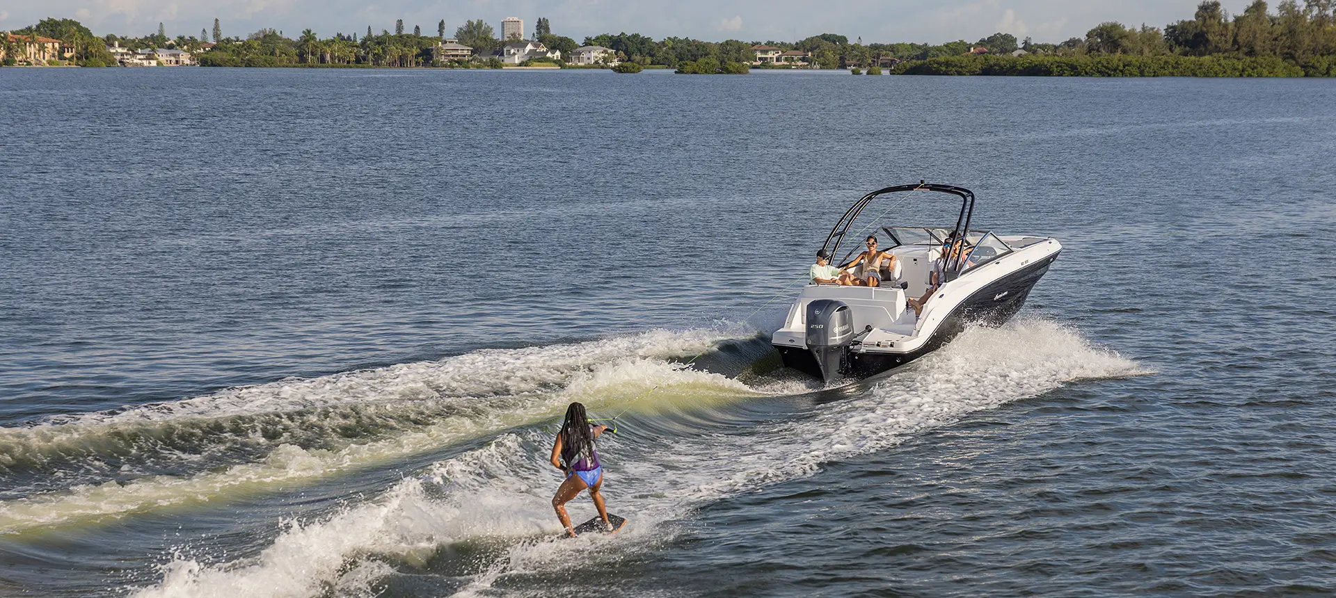 rear view of wakeboard rider being towed behind a hurricane sundeck 235 ob