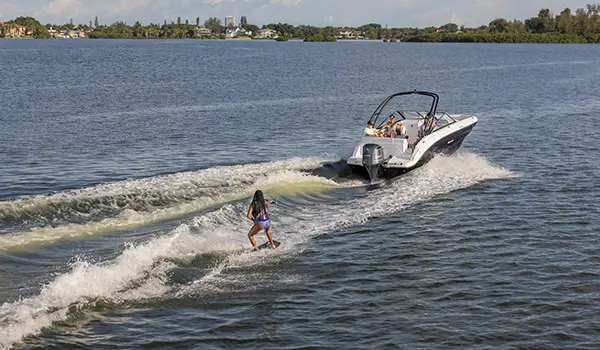 rear view of wakeboard rider being towed behind a hurricane sundeck 235 ob