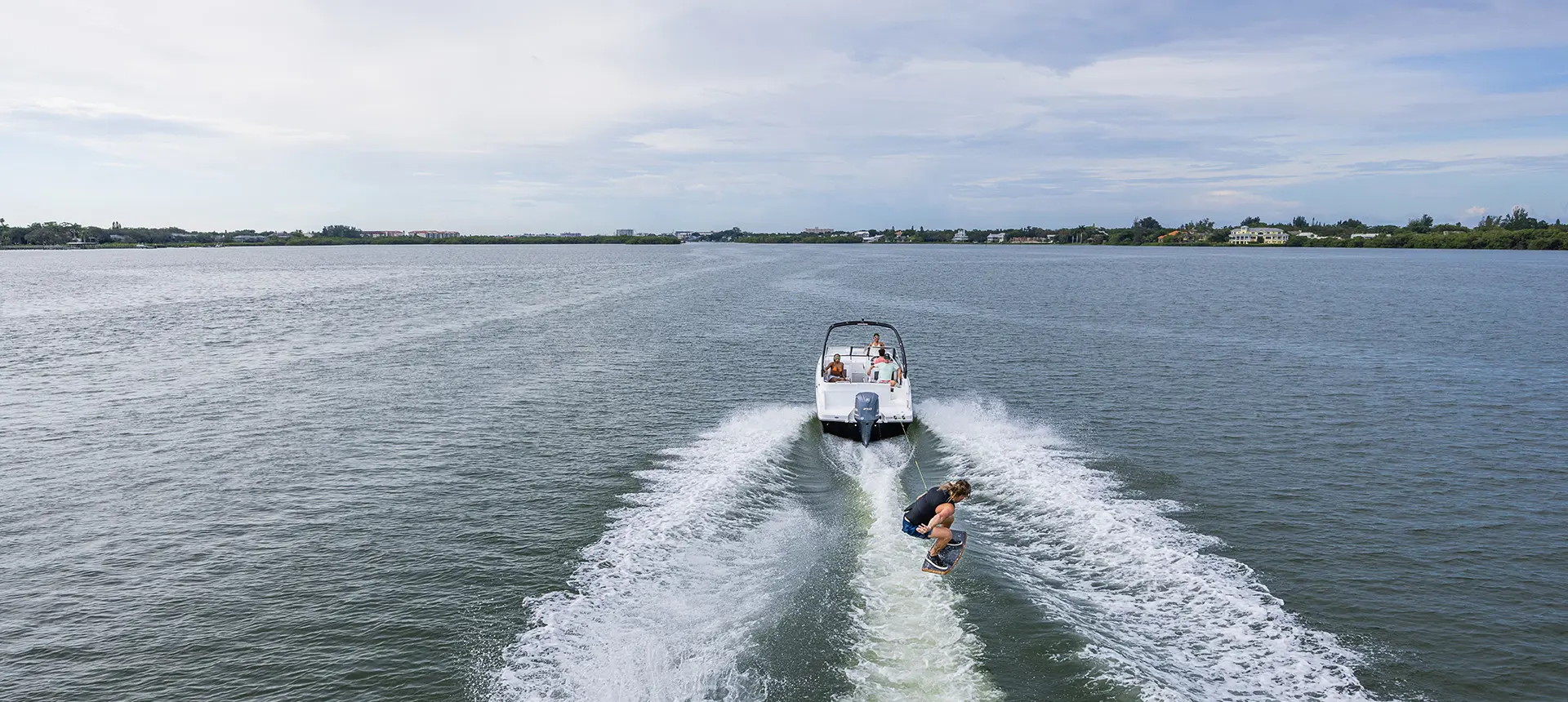 wakeboarder jumps waves behind a hurricane sundeck 235 ob