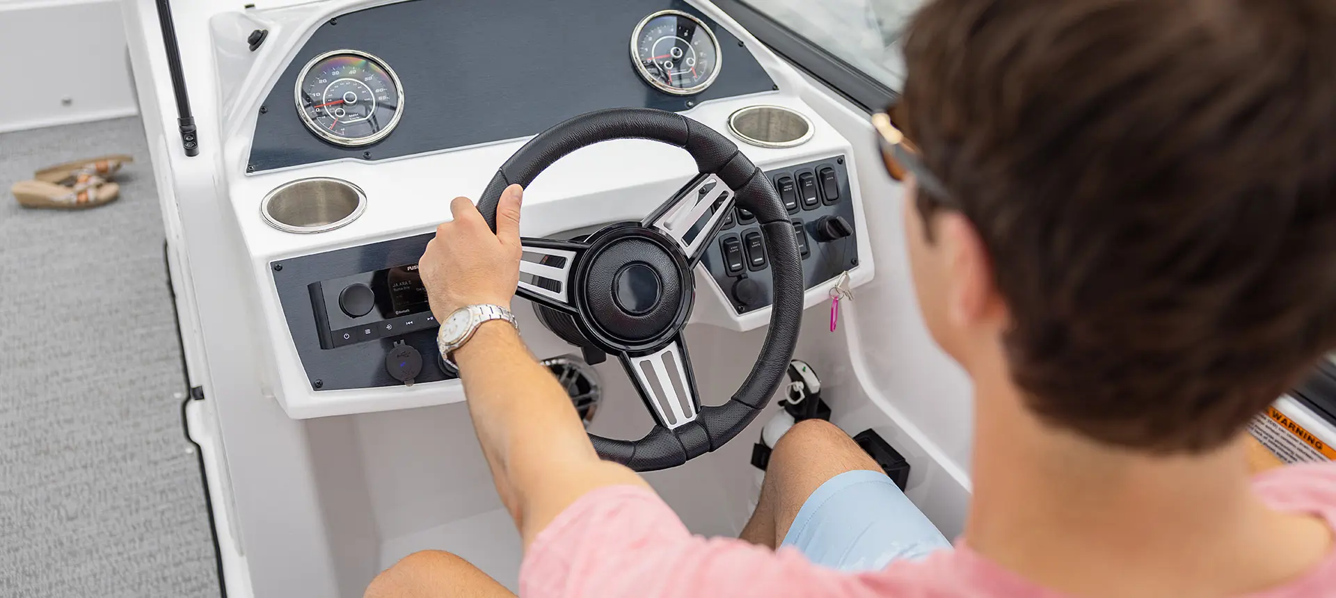 captain controls steering wheel on a hurricane sundeck 235 ob