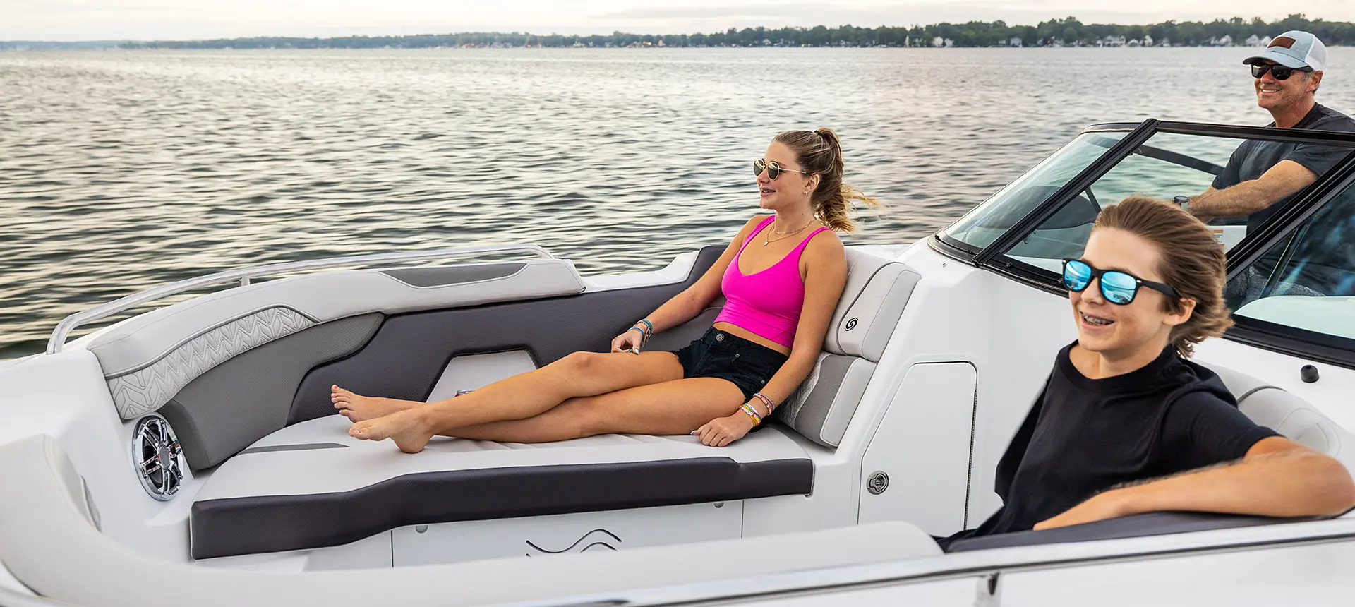 brother and sister enjoying the lake on a hurricane sundeck 2400 ob deck boat