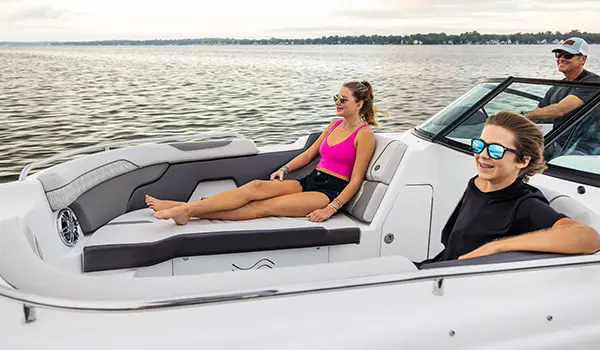 brother and sister enjoying the lake on a hurricane sundeck 2400 ob deck boat