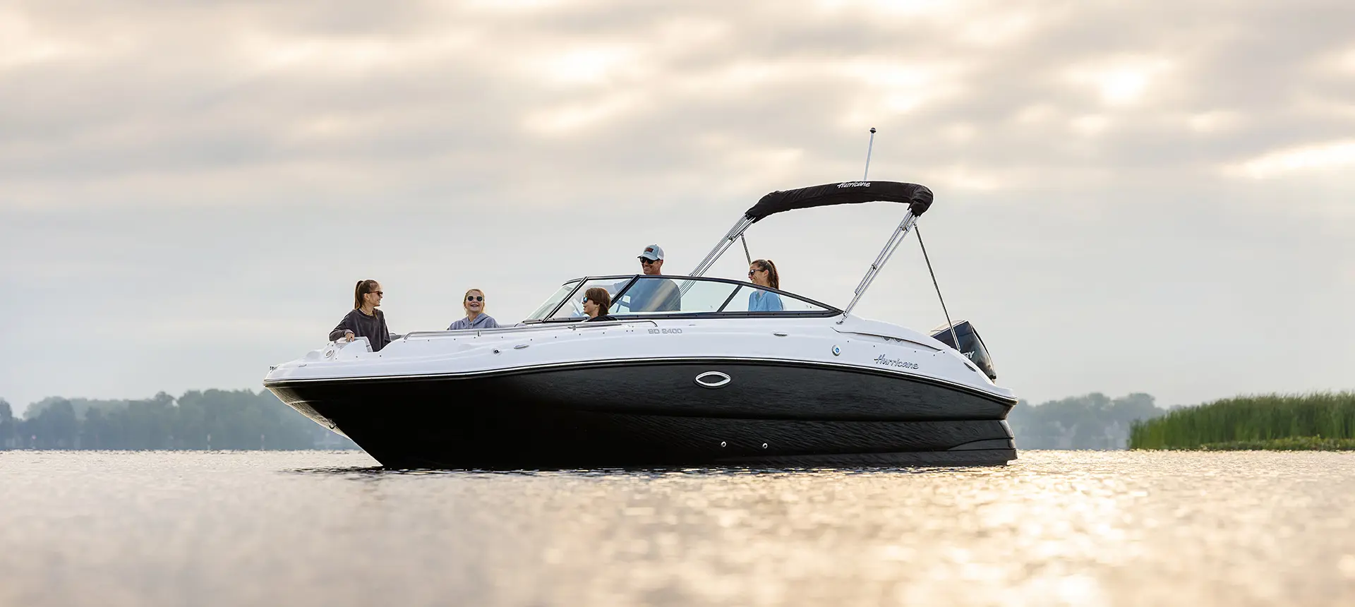 family enjoying the lake on a hurricane sundeck 2400 ob deck boat