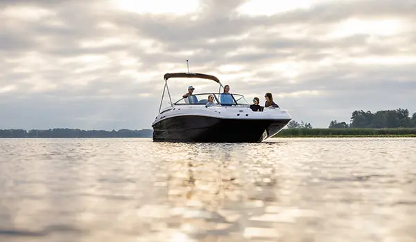 bow focused view of a family relaxing on a hurricane sundeck 2400 ob deck boat