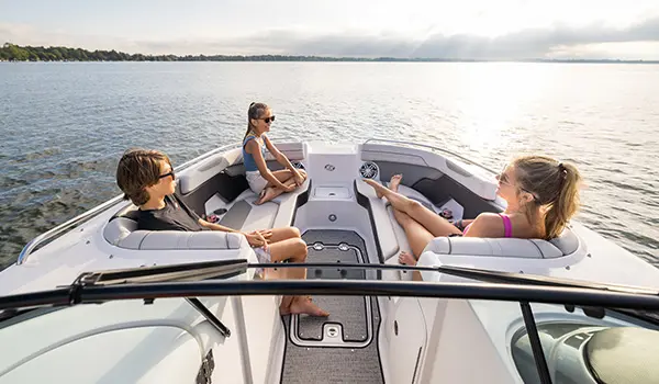 siblings relaxing on the bow seating on a hurricane sundeck 2400 ob deck boat