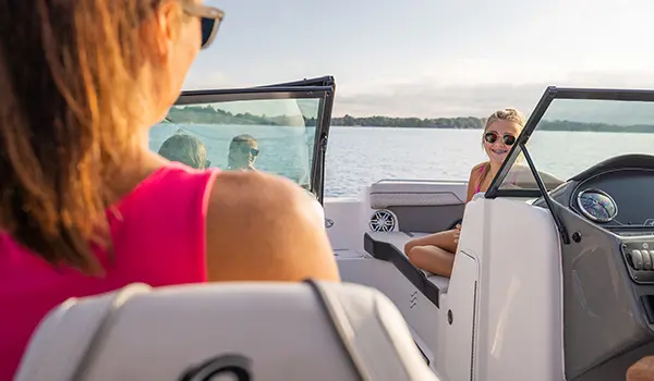 girl smiling at her mom on a hurricane sundeck 2400 ob deck boat