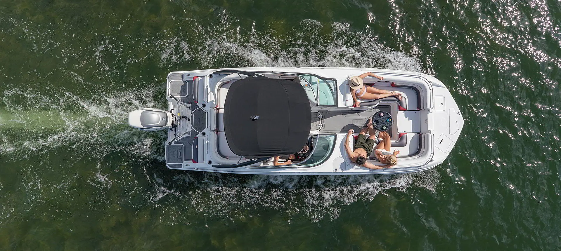 Overhead view of a Hurricane SunDeck 2486 OB cruising on lake.