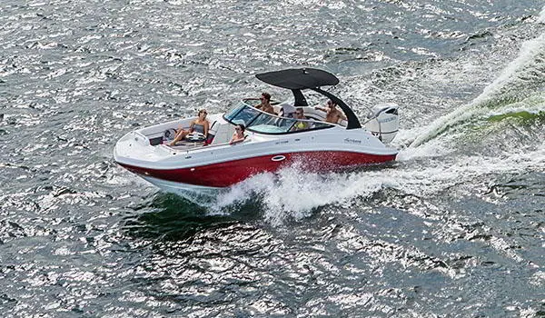 Front view of a Hurricane SunDeck 2486 OB cruising on lake.